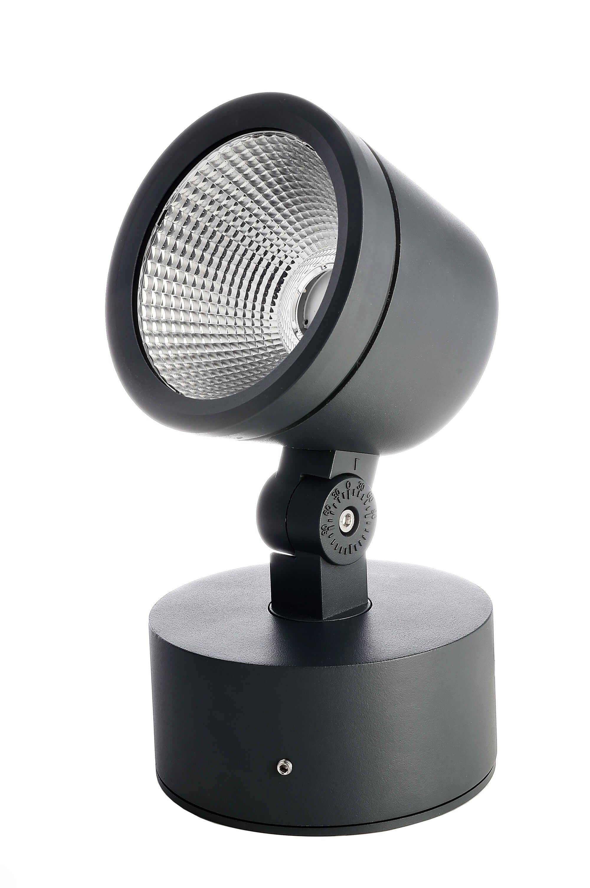 Okrągła, czarna lampa LED na cylindrycznym cokole; przeznaczona do kierunkowego oświetlenia wnętrz.