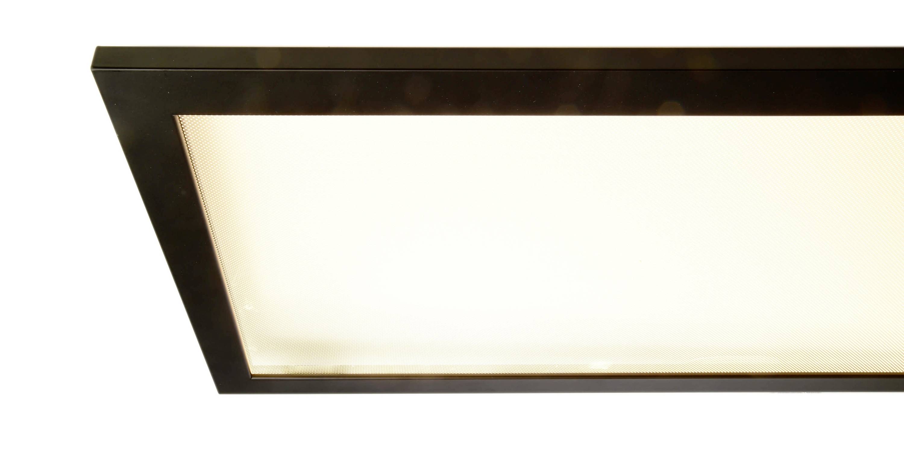 Prostokątna lampa LED, widoczna z góry, z czarną ramką i jasno świecącą białą powierzchnią.