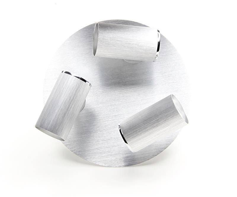 Trzy smukłe, cylindryczne reflektory są symetrycznie rozmieszczone na okrągłej, srebrnej podstawie.