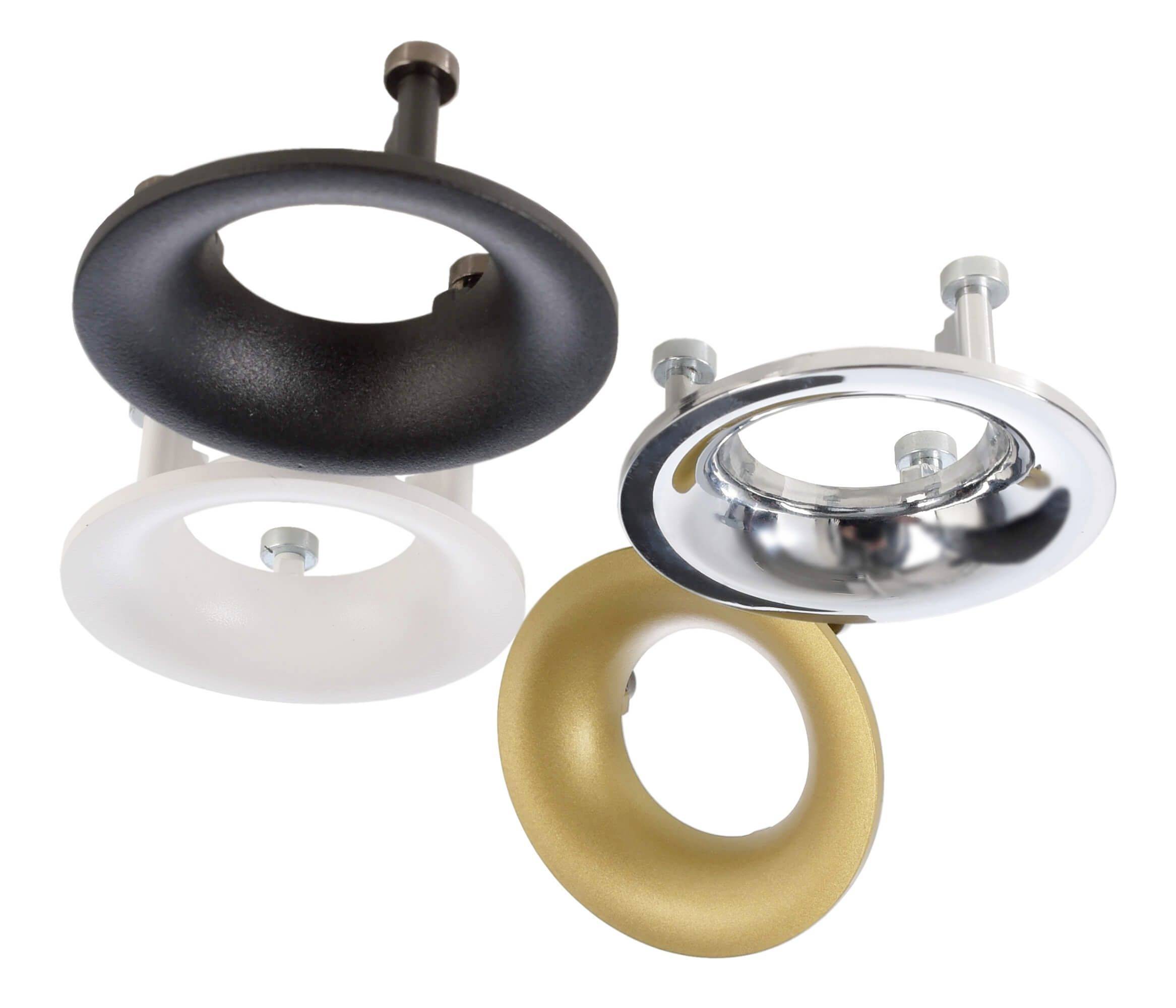 Trzy okrągłe oprawki lamp w kolorach czarnym, białym i złotym, częściowo błyszczące, zamocowane śrubami, na białym tle.