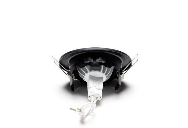 'Zbliżenie małego, okrągłego, czarnego głośnika widzianego od dołu, z widocznymi kablami i uchwytami mocującymi.'