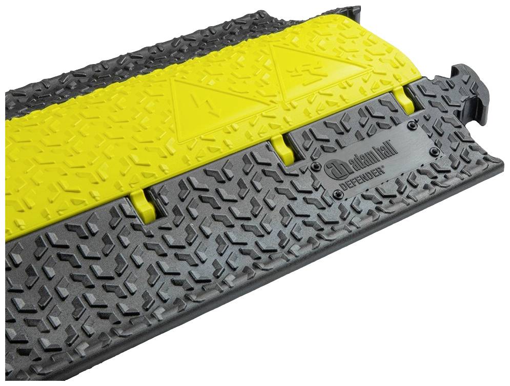 Żółto-czarny system zabezpieczenia kabli z antypoślizgową powierzchnią wykonaną z wytrzymałego materiału, odpowiedni do stosowania na placach budów lub podczas imprez.