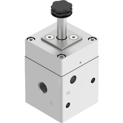Prostokątny element mechaniczny z czarnym pokrętłem na górze. Posiada kilka złączy po bokach.