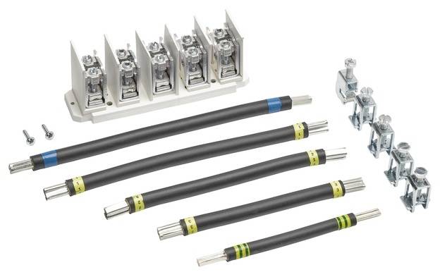 Kilka przewodów i elementów akcesoriów do połączeń elektrycznych. W lewym górnym rogu blok przyłączeniowy, po prawej stronie kilka zacisków kablowych.