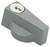 Szary, prostokątny element metalowy z otworem na klucz u góry, prawdopodobnie mechanizm zamykający lub gałka.