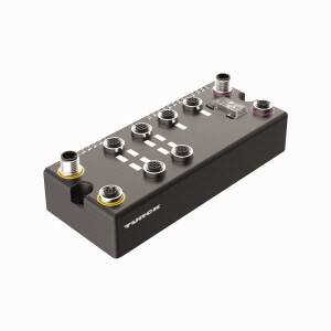 Prostokątne czarne urządzenie elektroniczne z wieloma złączami na górnej powierzchni, oznaczone napisem 'Turck'.