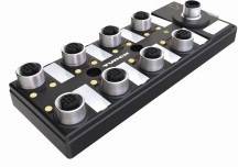 Wielostykowy złącz z ośmioma okrągłymi stykami na prostokątnej czarnej podstawie, stosowany w przemysłowych systemach okablowania.