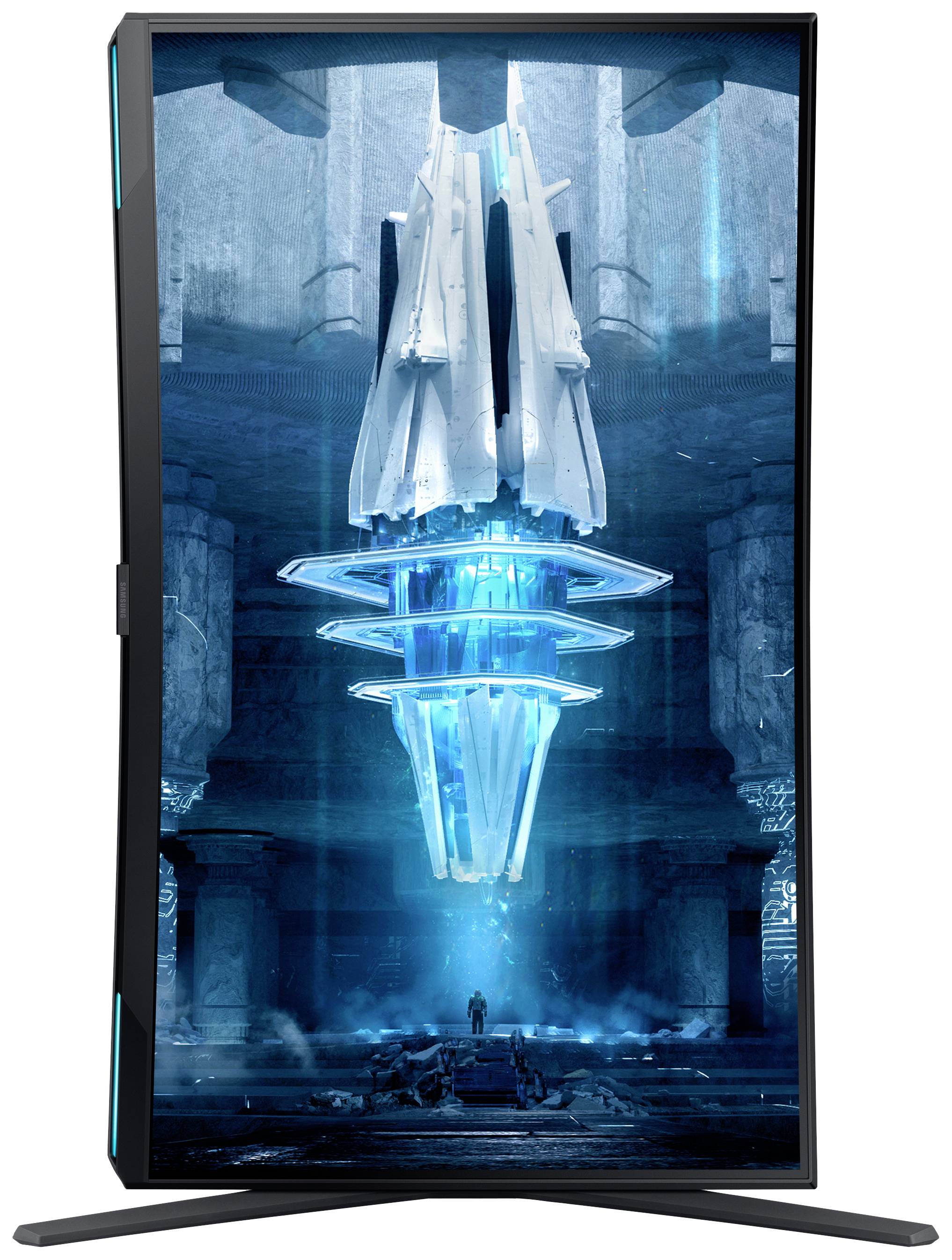 Niebieskawy, futurystyczny artefakt unosi się w ciemnym pomieszczeniu. Małga osoba stoi poniżej i przygląda się lśniącemu obiektowi.