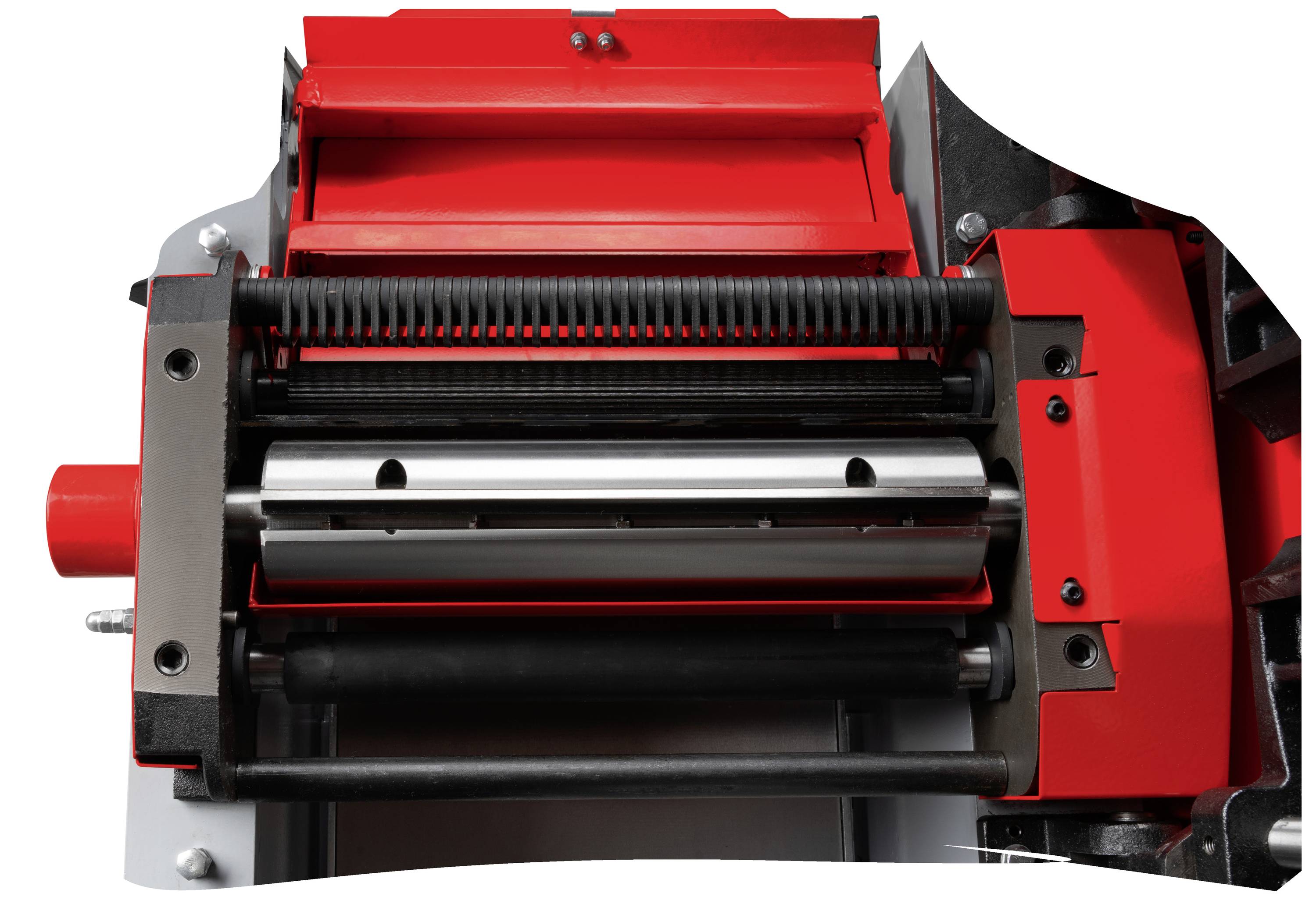 Czerwona i czarna przemysłowa maszyna z walcami i dźwigniami, prawdopodobnie prasa przemysłowa, jest pokazana z bliska.