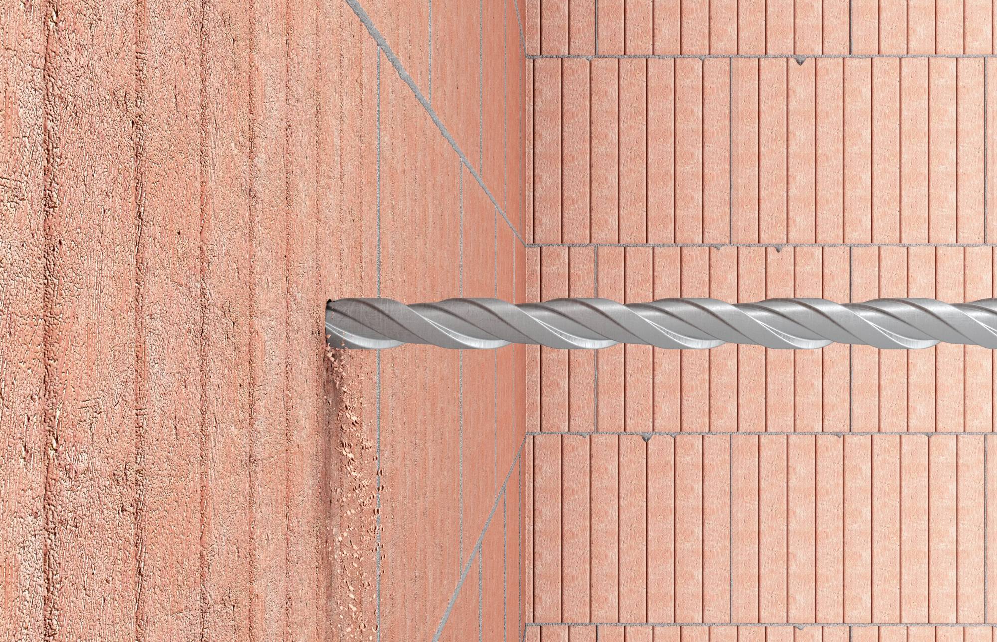 Szary Wiertacz wwierca dziurę w murze z cegły.