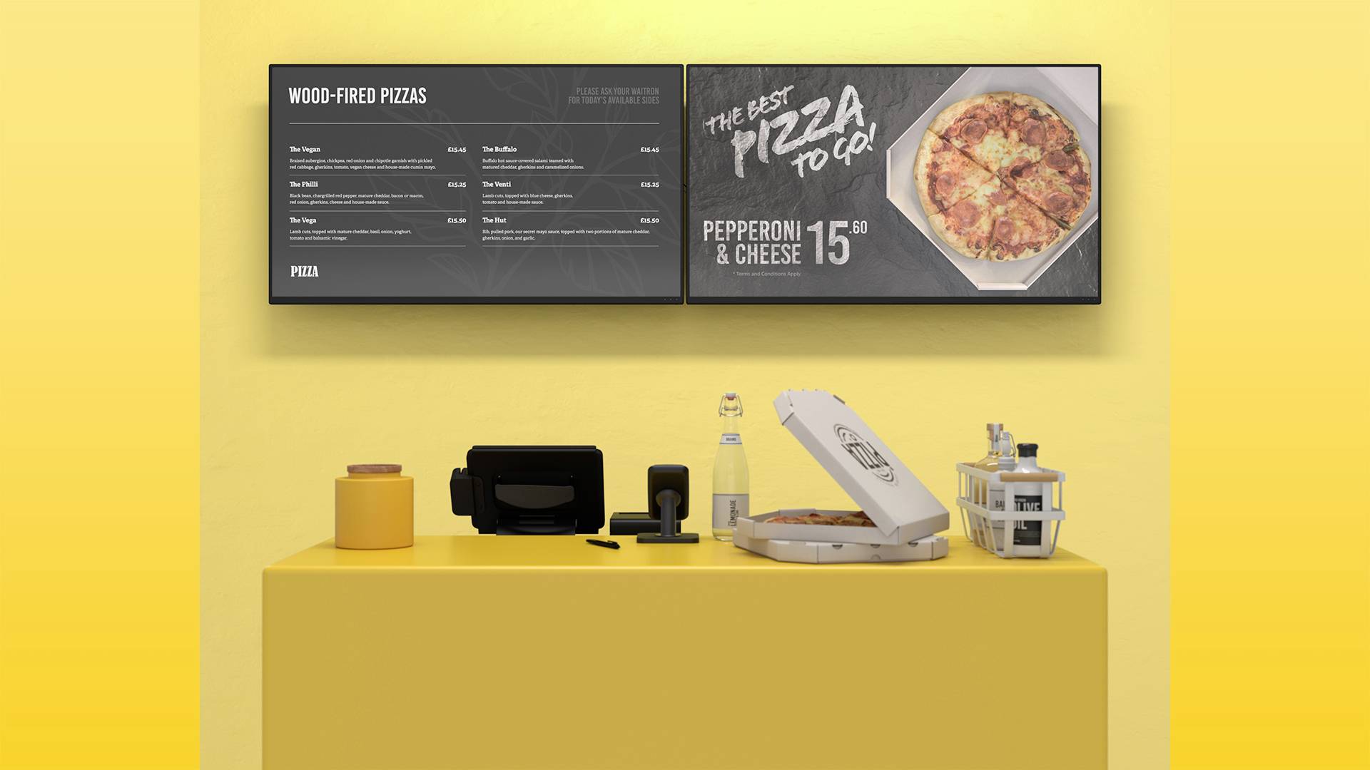 Dwa ekrany wyświetlają menu z pizzami pieczonymi w piecu kamiennym. Poniżej znajduje się żółta lada z pizzą w otwartym pudełku.