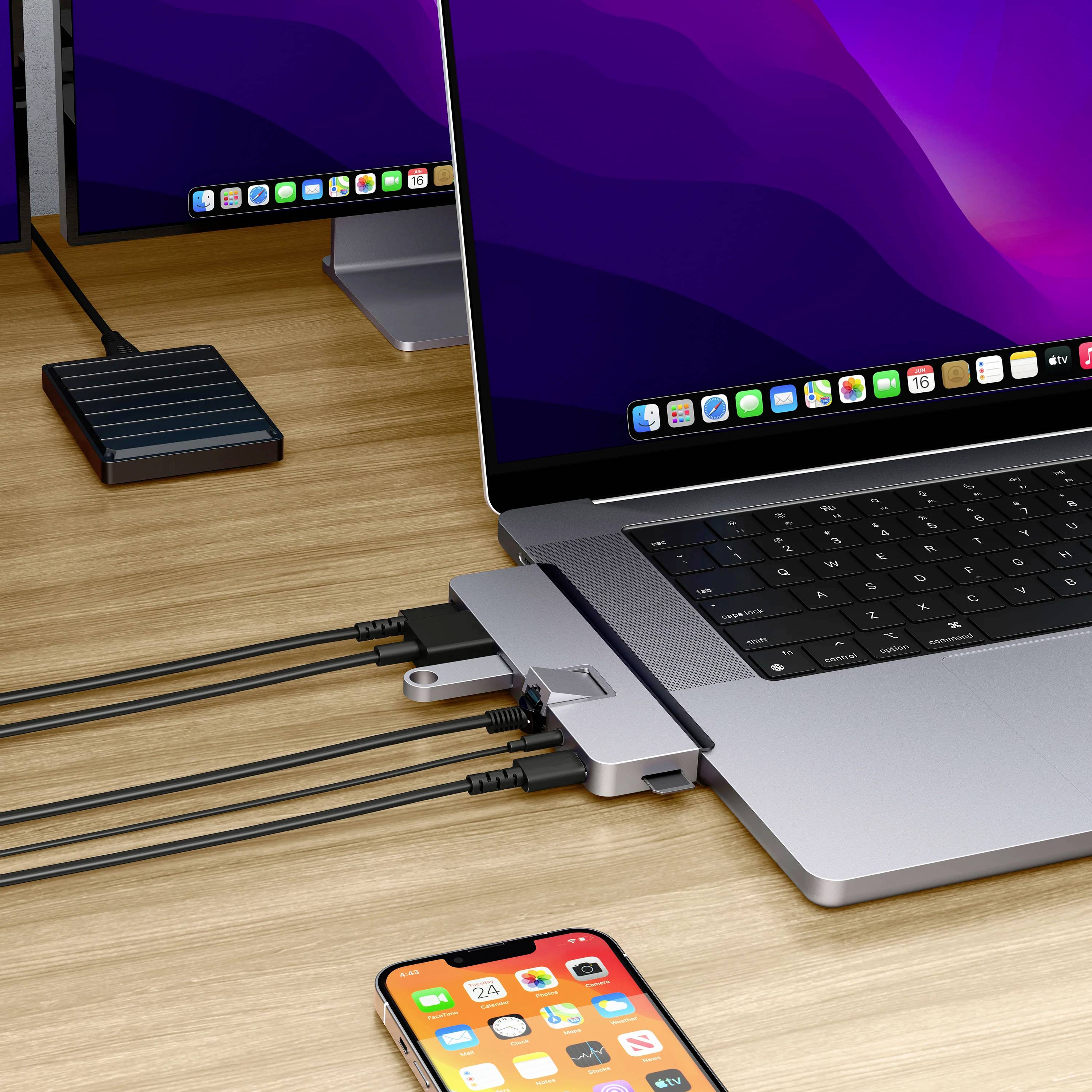 Laptop na biurku jest podłączony do kilku urządzeń, w tym smartfona i monitorów wyświetlających podobny widok.