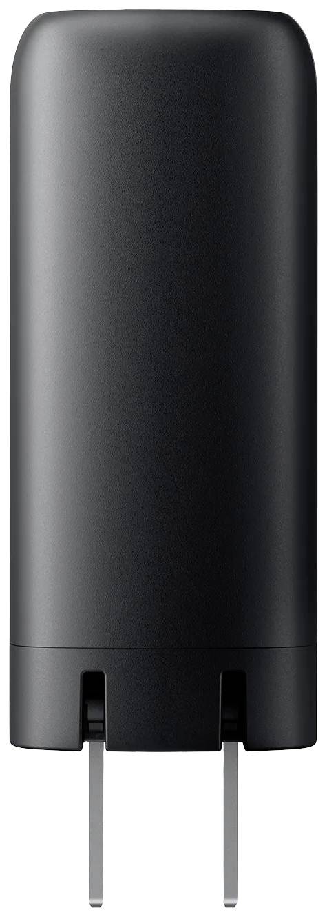 Czarny, cylindryczny ładowarka z dwoma metalowymi stykami od spodu, przystosowana do użycia w gniazdkach ściennych.