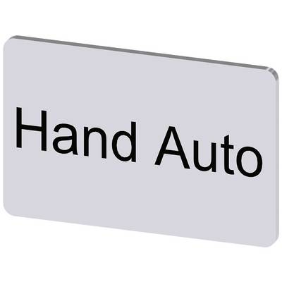 Prostokątna tablica informacyjna wyświetla napis 'Hand Auto' i prawdopodobnie wskazuje na ręczne lub automatyczne ustawienie.