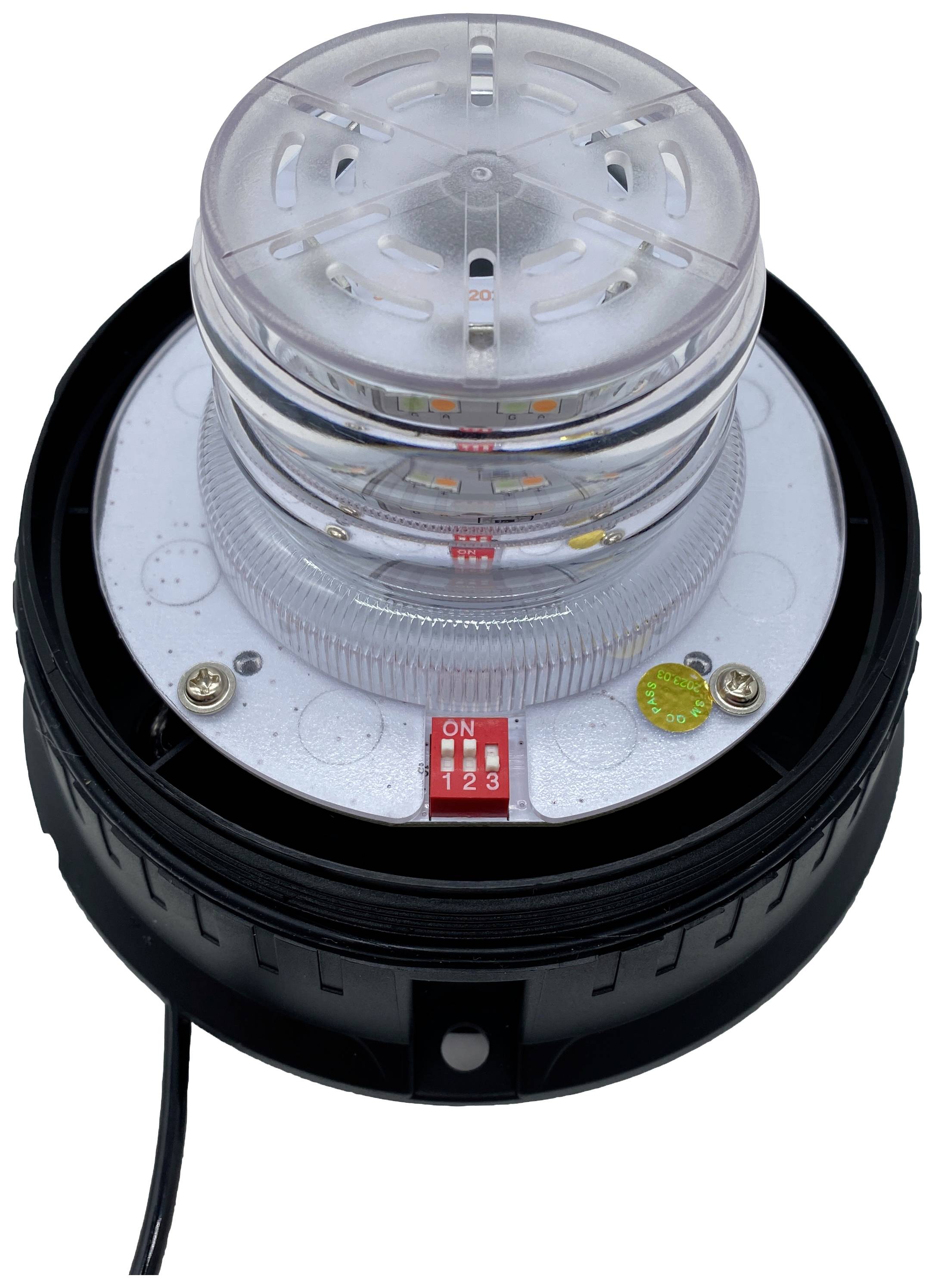 Okrągła, przezroczysta lampa LED w kształcie latarni morskiej z czarnymi elementami podstawy. Posiada skalę i przełączniki do regulacji ustawień.