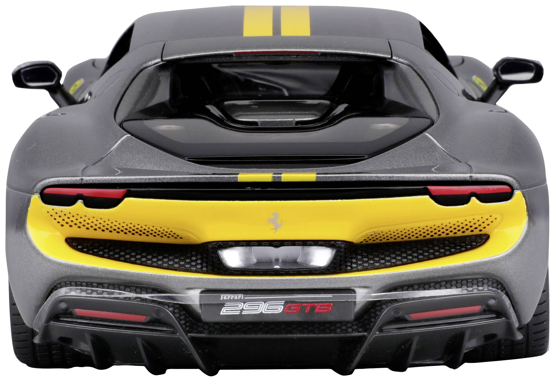 Widok z tyłu szarego samochodu sportowego z żółtymi pasami, żółtym logo i czerwonymi akcentami. Charakterystyczny układ wydechowy i aerodynamiczna sylwetka.