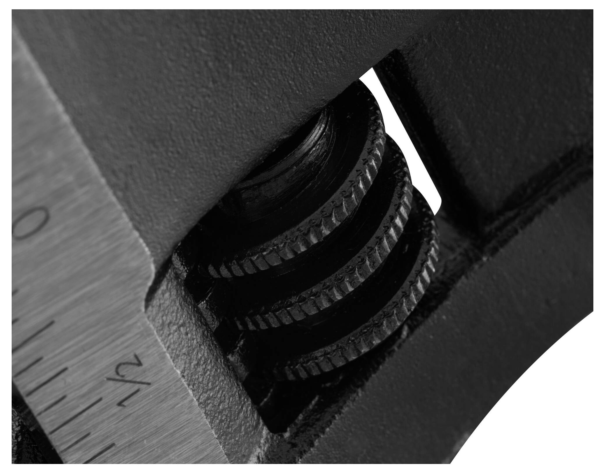 Zbliżenie klucza nastawnego z fokusem na śrubę regulacyjną i skalę.