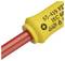 Żółte narzędzie z czerwonym czubkiem, na którym wydrukowane są oznaczenia bezpieczeństwa oraz numery IEC służące do oznaczania jakości.