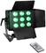Czarny reflektor LED z dziewięcioma zielonymi światłami, z regulowanymi klapami i pilotem. Idealny do efektów scenicznych.