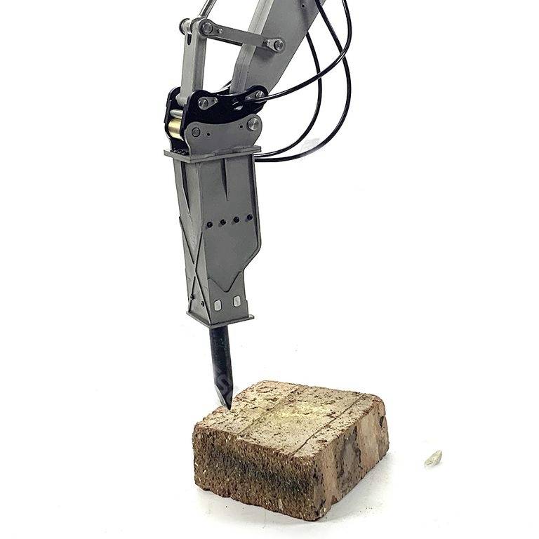 Ramię robotyczne z metalowym chwytakiem wbijające się w cegłę. Mechaniczny ruch prezentuje precyzję i siłę urządzeń przemysłowych.