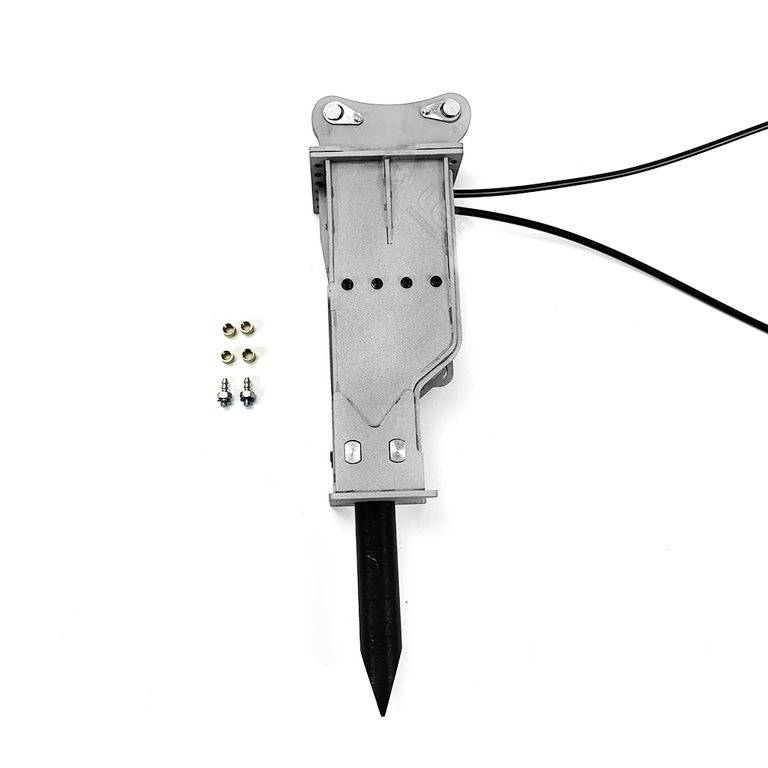 Szary element mechaniczny z przewodami, prawdopodobnie część jakiegoś urządzenia, leży na białej powierzchni. Obok niego znajdują się małe śruby.