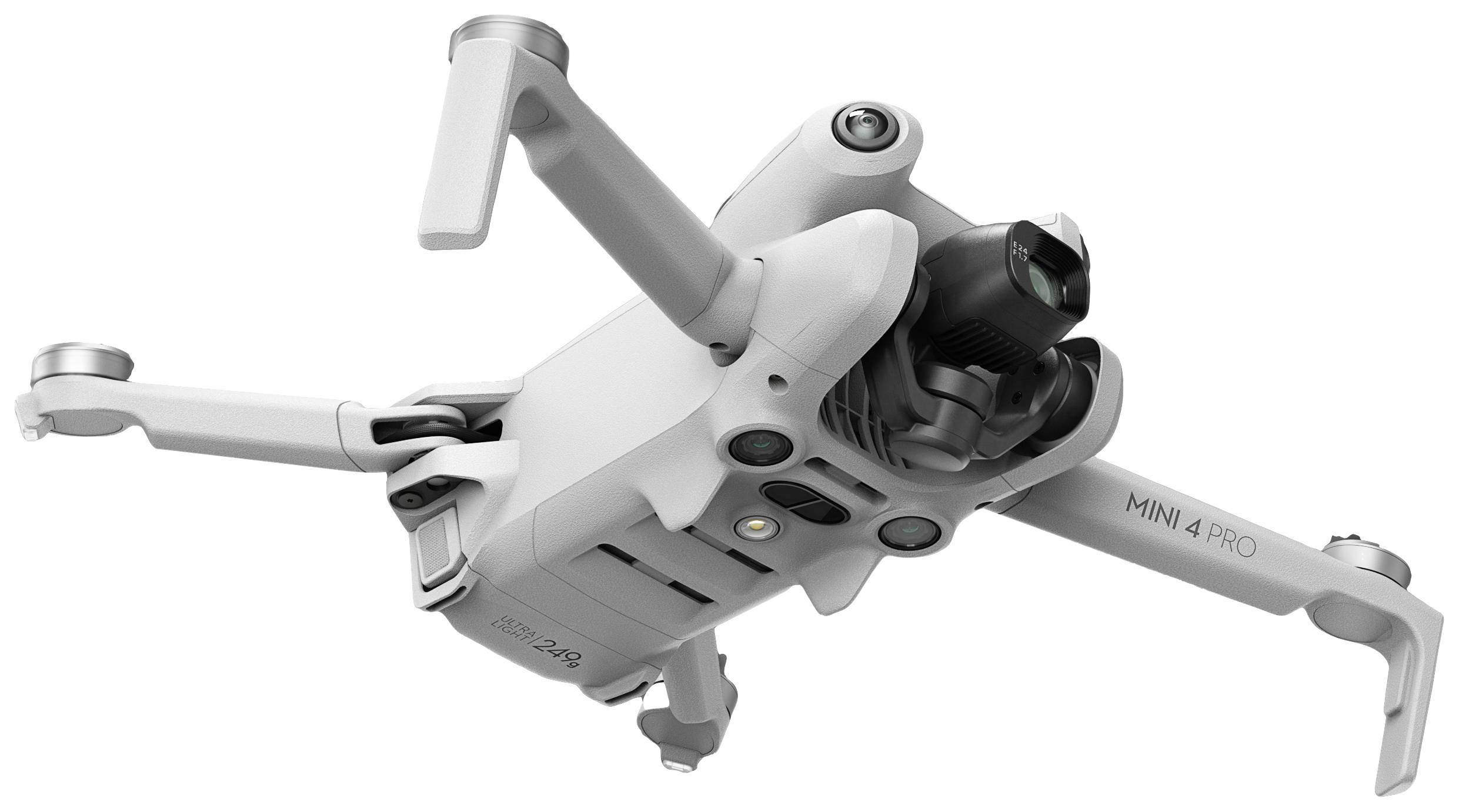 Biały dron unosi się w powietrzu. Posiada cztery śmigła i kamerę z przodu. Na obudowie napis 'Mini 4 Pro'.