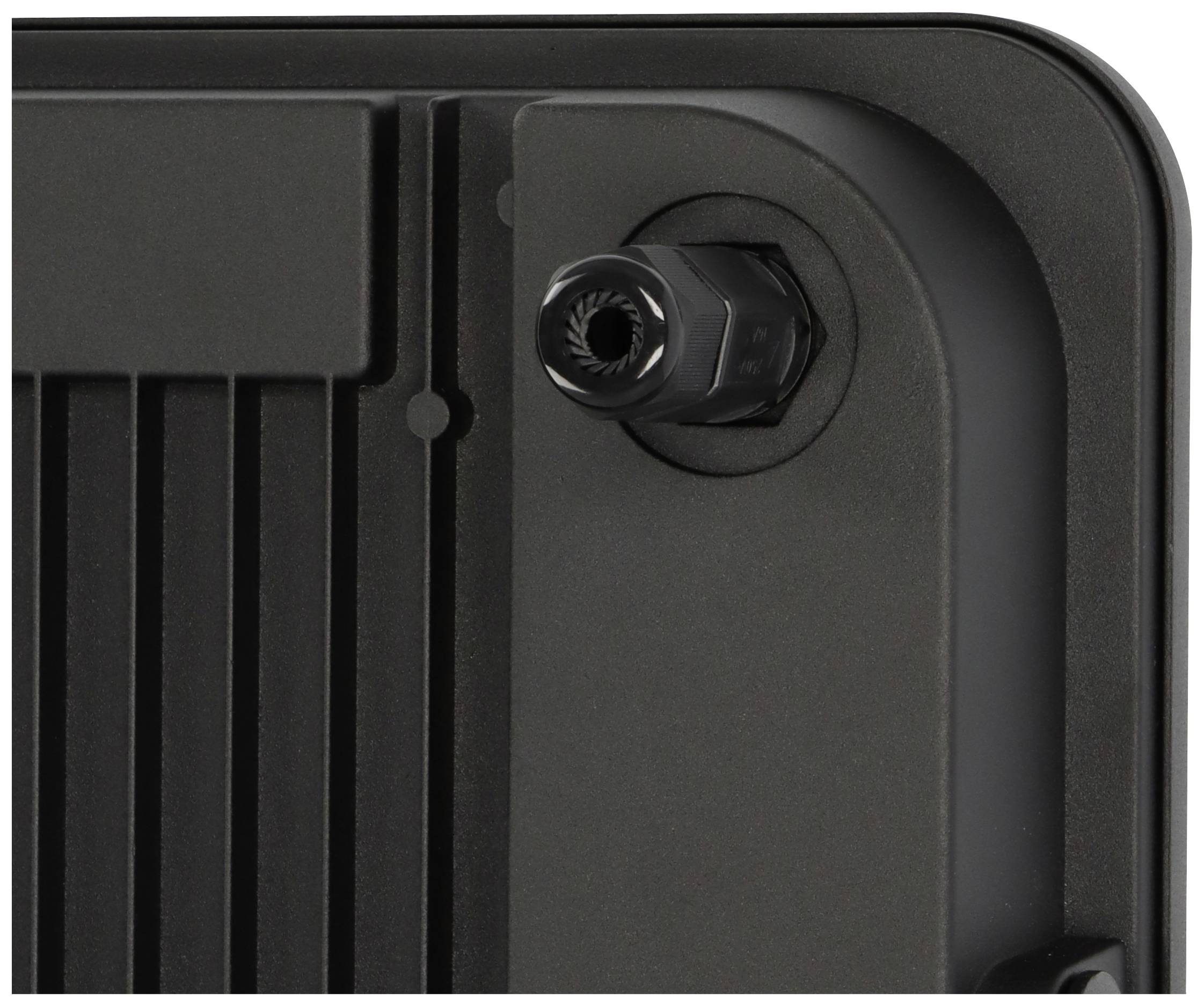 Zbliżenie czarnego urządzenia z wejściem kablowym w prawym górnym rogu. Po lewej stronie obudowy widoczne są żeberka chłodzące.