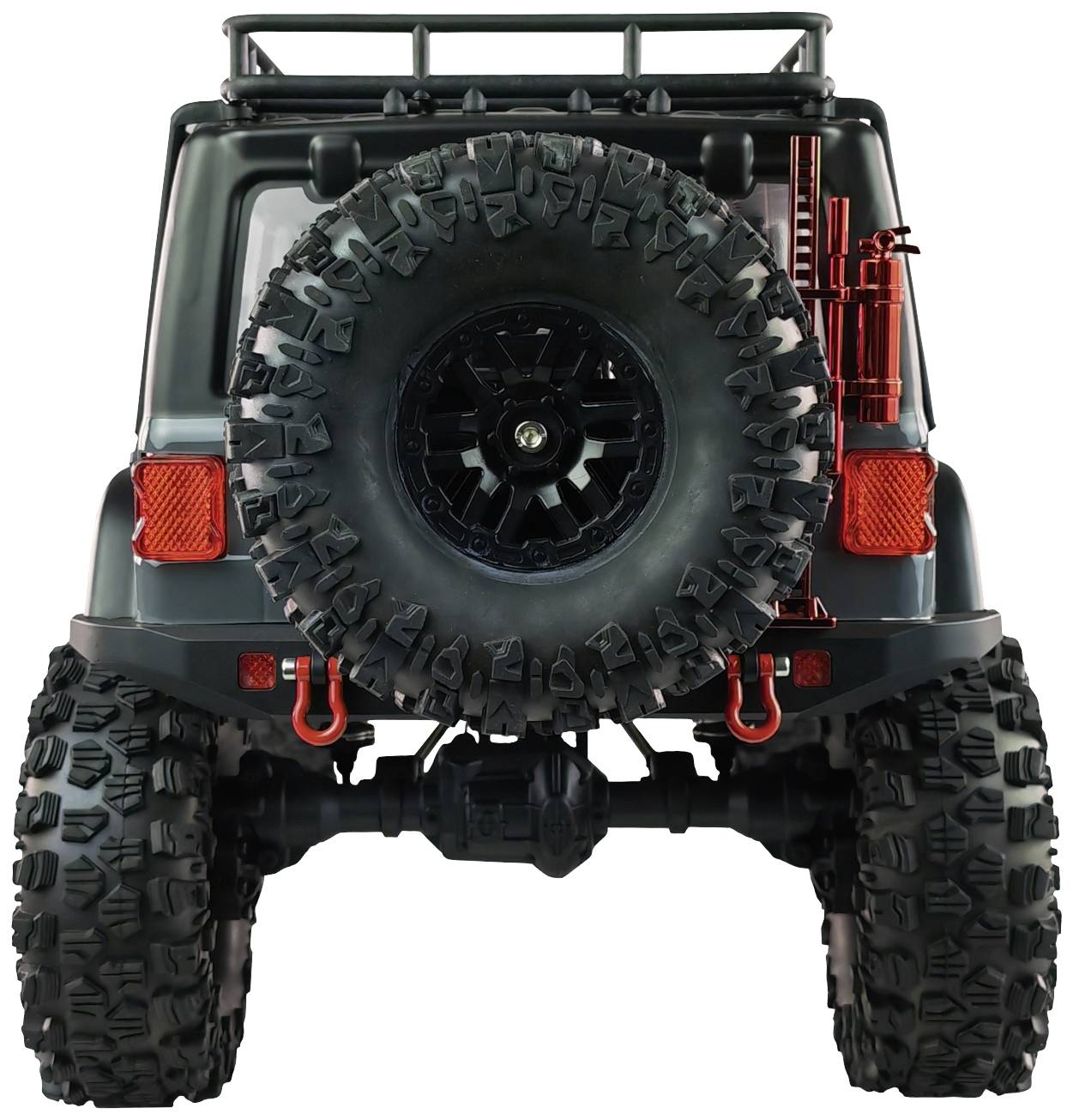 Terenówka widziana od tyłu z dużymi kołami, kołem zapasowym z tyłu i czerwonymi dodatkami, przystosowana do jazdy w terenie.