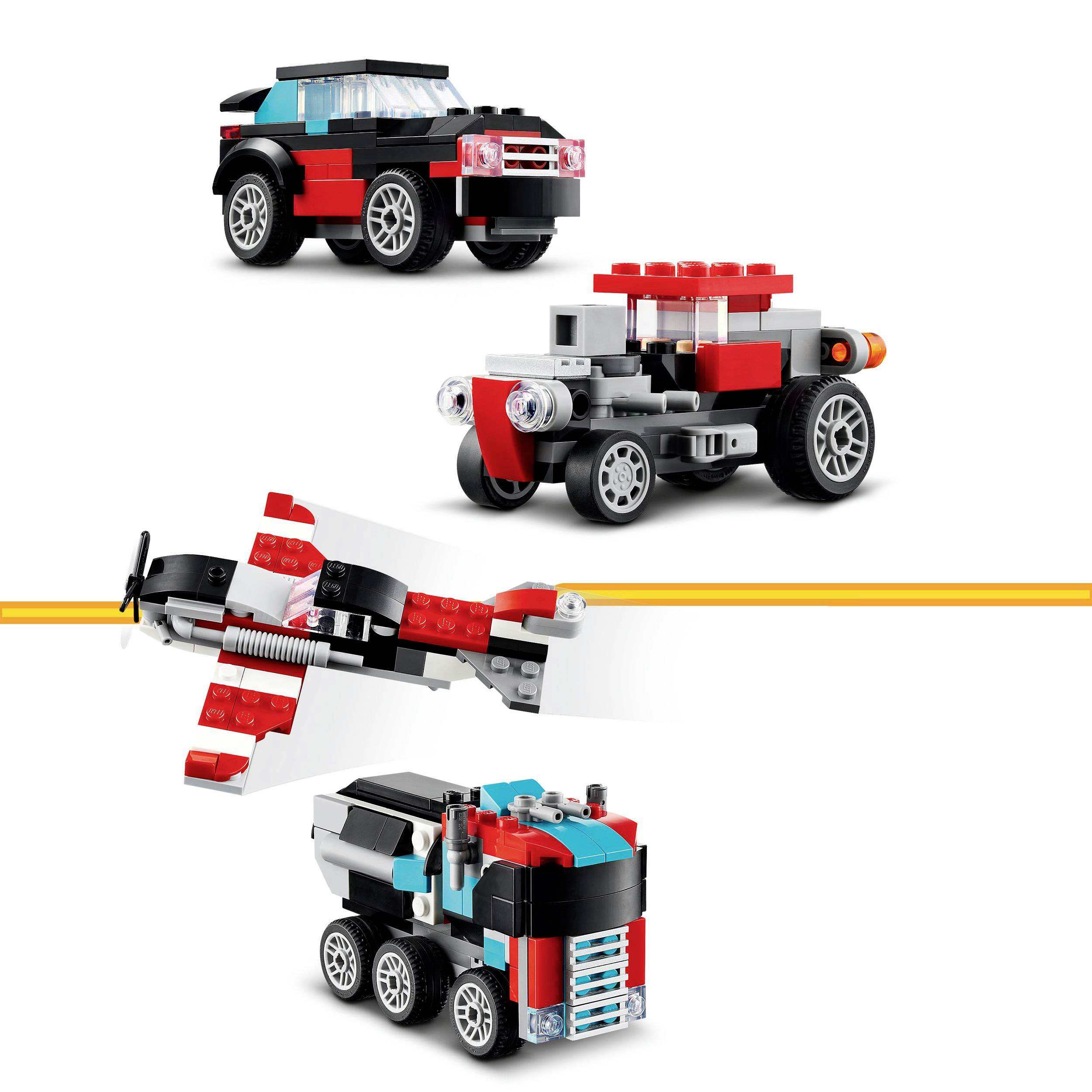 Trzy małe, kolorowe pojazdy zabawkowe zbudowane z klocków Lego: samochód, samolot i terenówka, każdy w kolorach czerwonym, czarnym i szarym.