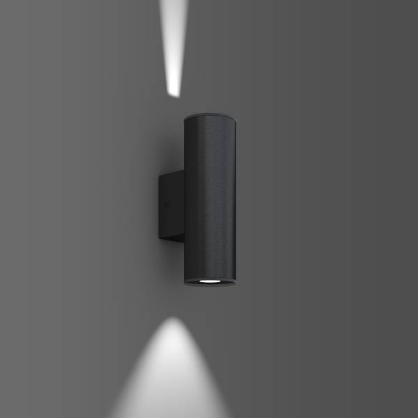 Nowoczesna czarna lampa ścienna na szarej ścianie, rzucająca światło w górę i w dół. Idealna do stylowego oświetlenia wnętrza.