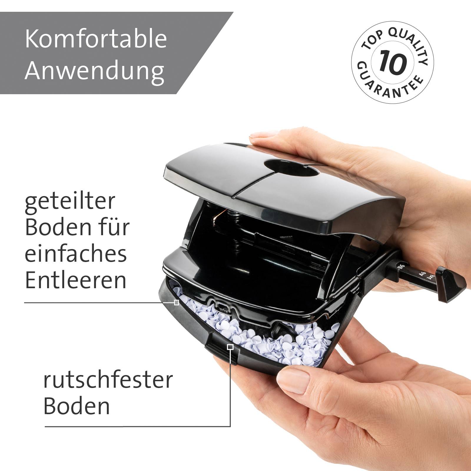 Dłoń trzyma dziurkacz z tekstem: 'Komfortowe użycie', 'Antypoślizgowa podłoga' oraz 'Gwarancja najwyższej jakości'. Odpady po dziurowaniu widoczne na dole.