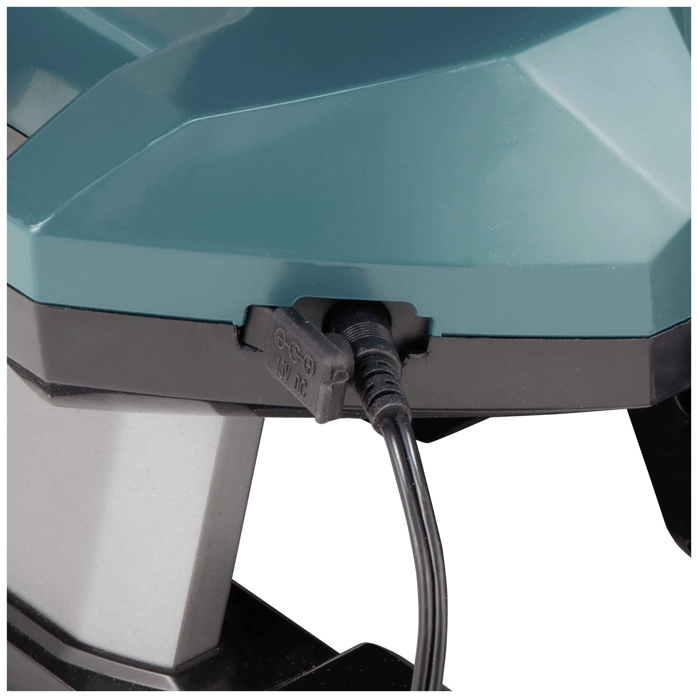 Turkusowe elektryczne urządzenie z podłączonym kablem ładującym. Na górze powierzchnia o geometrycznym kształcie. Urządzenie może być przeznaczone do użytku przemysłowego.