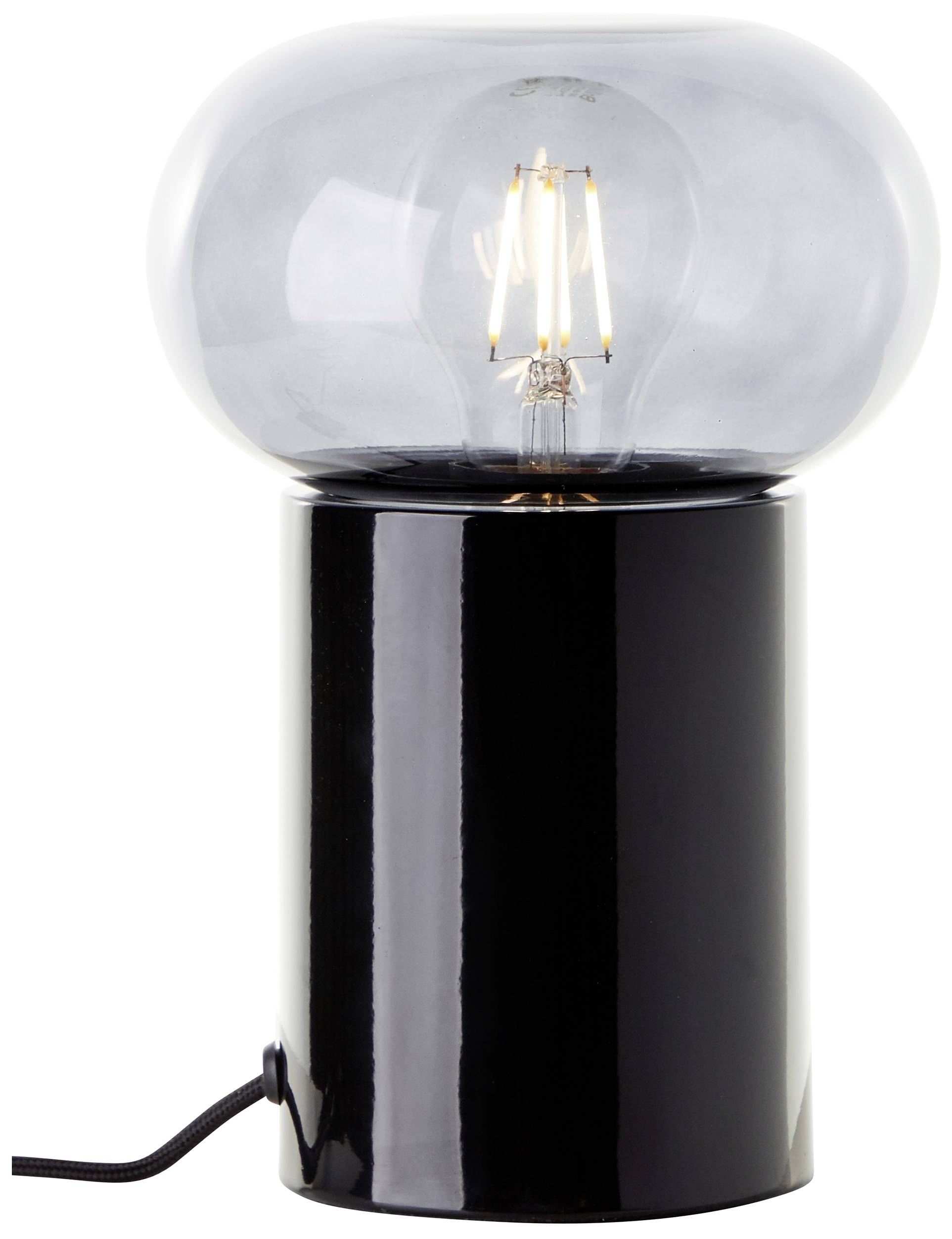 Nowoczesna lampa stołowa z czarną, cylindryczną podstawą i dużą, przezroczystą żarówką, która jest włączona.