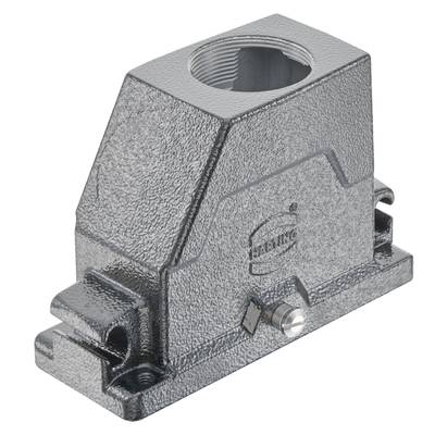 Srebrzyste metalowe obudowanie o strukturze trapezowej z centralnym otworem cylindrycznym, stosowane w zastosowaniach technicznych.