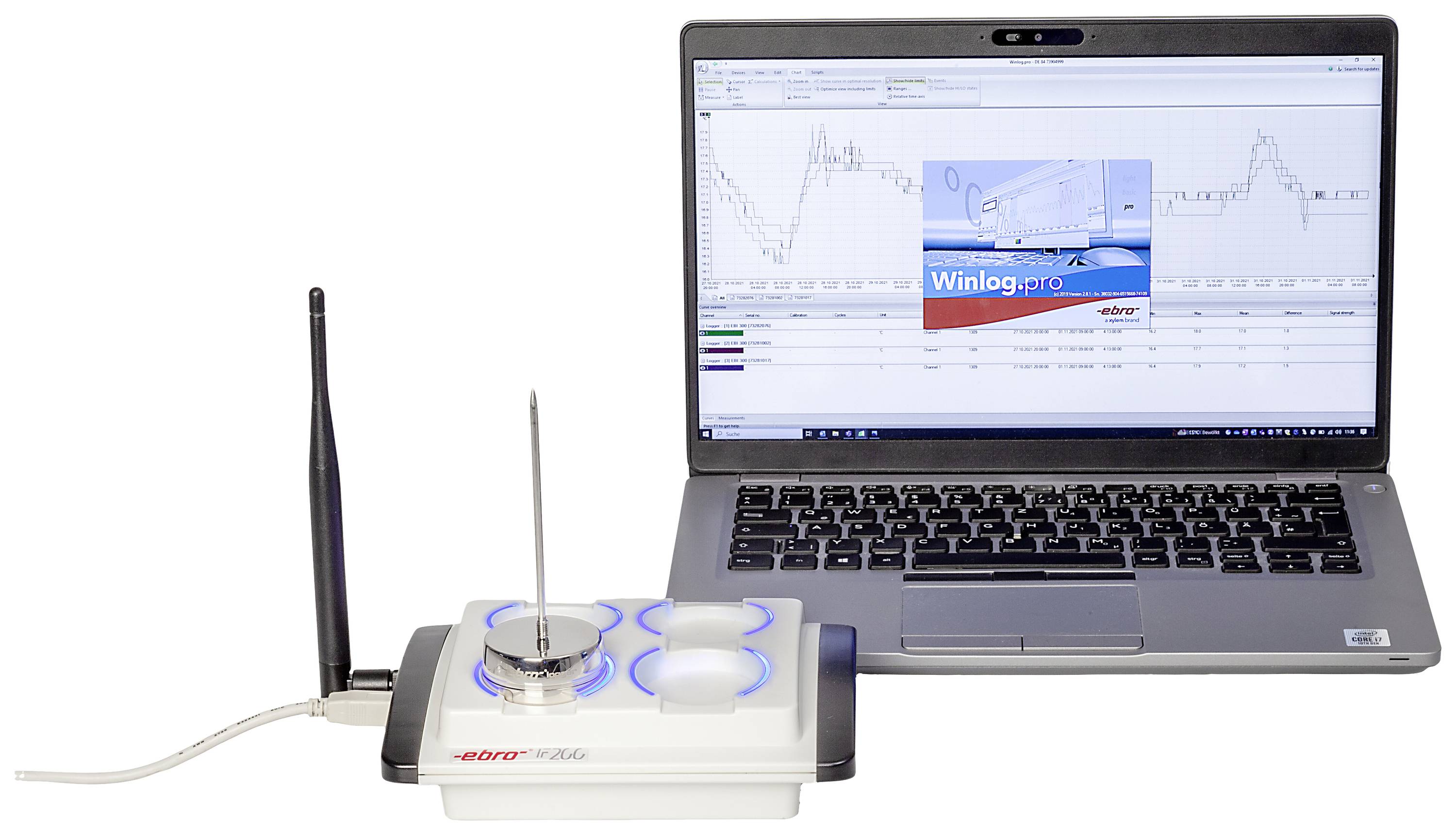Oprogramowanie 'Winlog.pro' na laptopie obok bezprzewodowego modułu sensorowego monitorującego temperaturę i wilgotność.