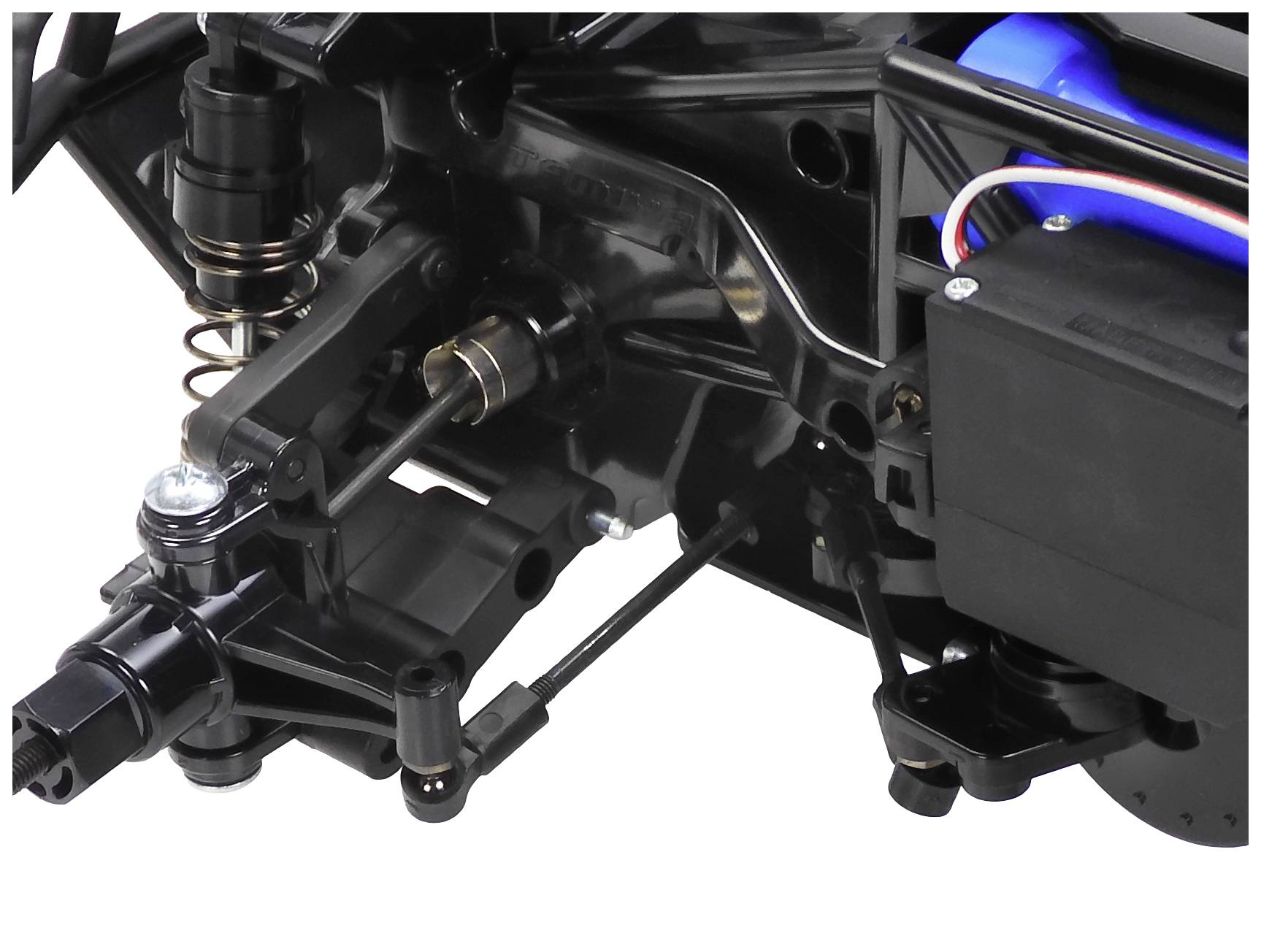 Zbliżenie czarnego amortyzatora i zawieszenia samochodu zdalnie sterowanego, z niebieskim elementem w tle.