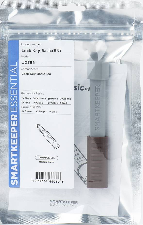 Opakowanie 'Smartkeeper Essential' z komponentem 'Lock Key Basic' i numerem modelu U03BN. Widoczna siatka opcji kolorystycznych i kod kreskowy.