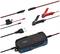 Ładowarka do akumulatorów z przewodami i zaciskami do podłączenia różnych typów baterii. Diody LED wskazują stan ładowania.