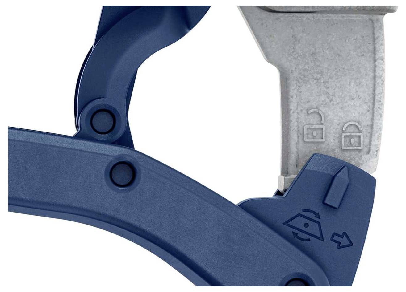 Klamra metalowa z dwoma symbolami: zamkniętego i otwartego zamka. Mechanizm dźwigniowy widoczny.