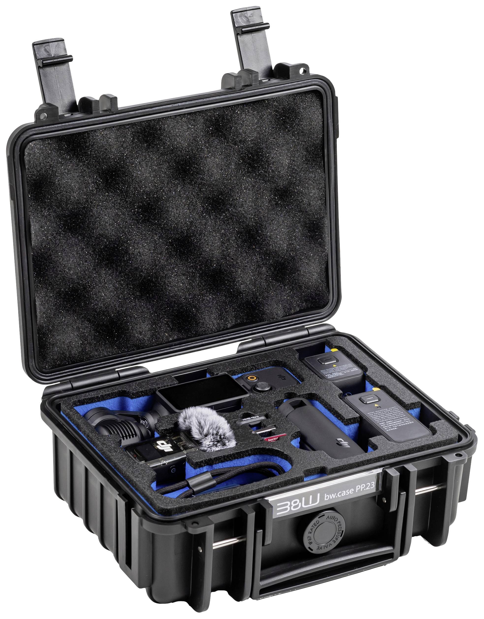 Czarny twardy kufer, otwarty i wyłożony wewnątrz niebiesko-czarną pianką. Zawiera akcesoria elektroniczne i części mikrofonowe.