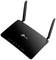 Czarny router Wi-Fi z dwiema antenami, z widocznym logo TP-Link z przodu. Wyświetla diody statusu zasilania, internetu i Wi-Fi.