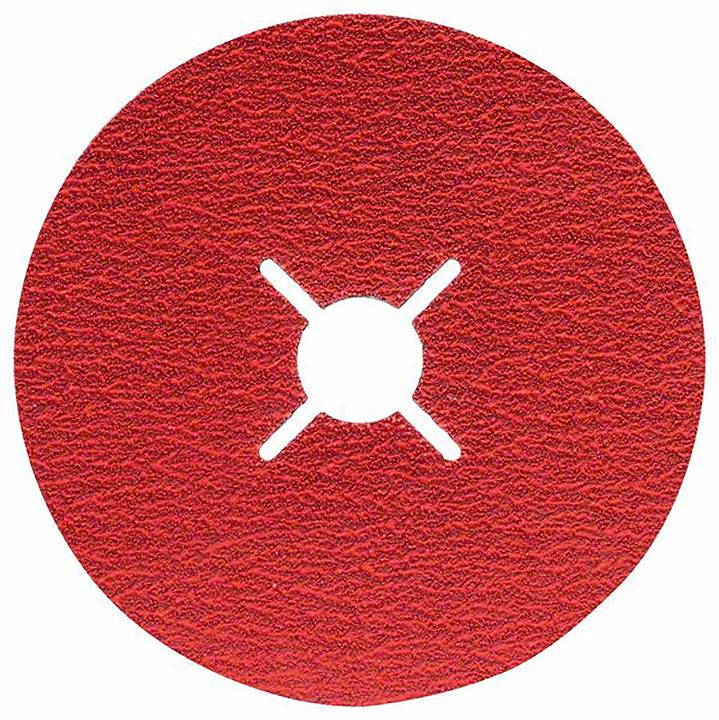 Okrągła, czerwona tarcza szlifierska z krzyżowym otworem pośrodku, na szorstkim podłożu.