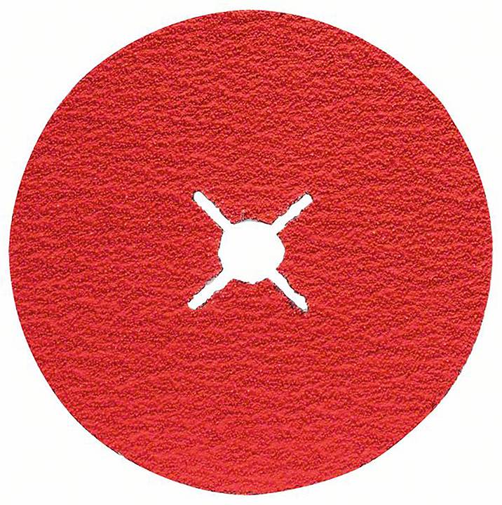 Okrągła, płaska, czerwona tarcza ścierna z krzyżowym otworem pośrodku, umieszczona na strukturalnym materiale.