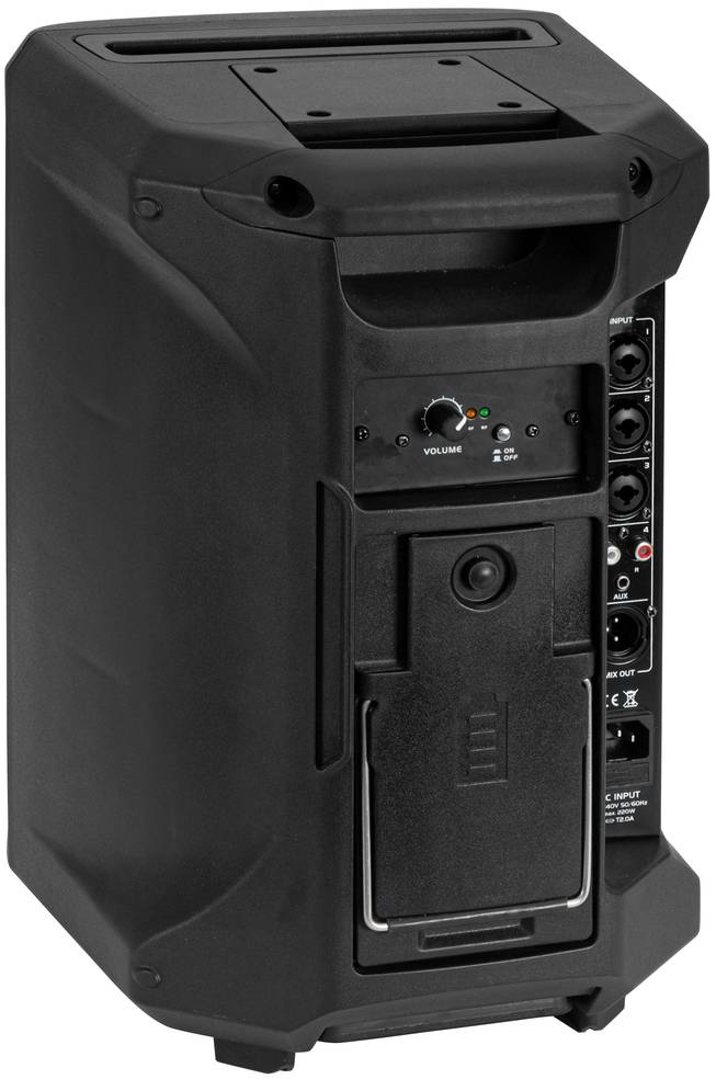 Czarny przenośny głośnik z regulatorem głośności, wieloma gniazdami audio oraz uchwytem do przenoszenia na górze.