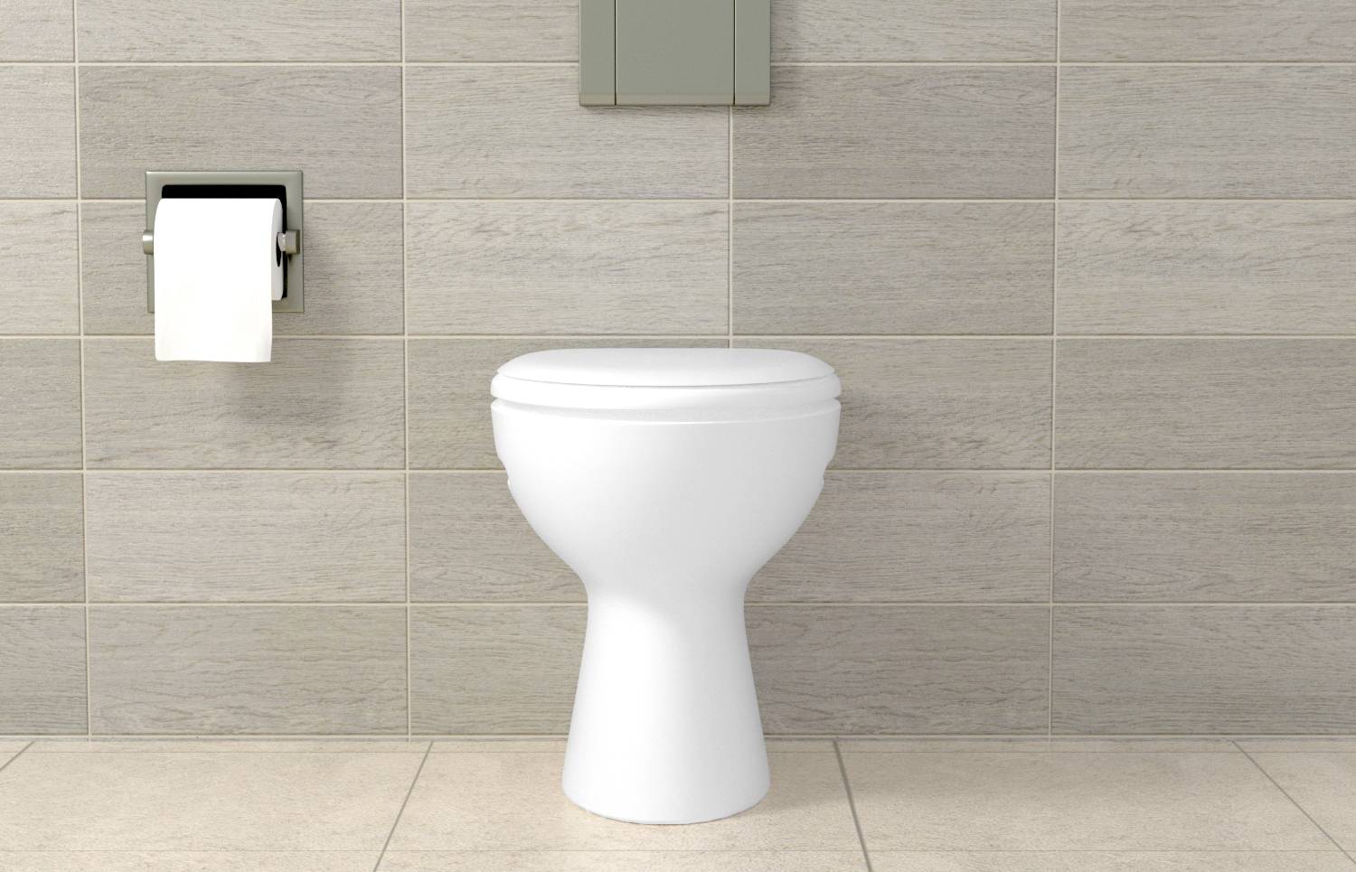 Biała miska toaletowa przed kafelkowaną ścianą z rolką papieru toaletowego po lewej stronie.