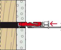 Diagram przedstawia śrubę mocowaną przez czerwony uchwyt kołka w ścianie drewniano-betonowej. Strzałka wskazuje kierunek wkręcania.