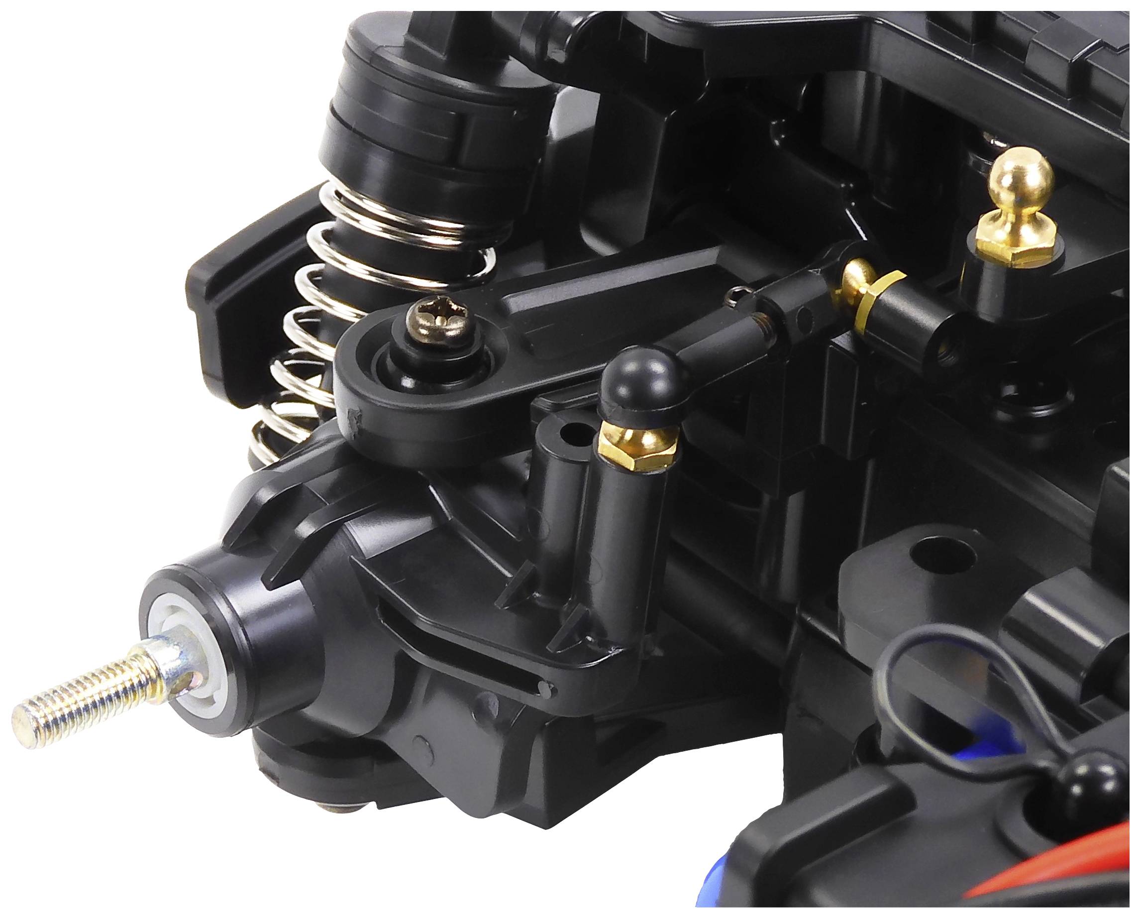 Zbliżenie czarnego mechanizmu wykonanego z tworzywa sztucznego i metalu, z widocznymi sprężynami i śrubami, prawdopodobnie fragment jakiegoś urządzenia technicznego.