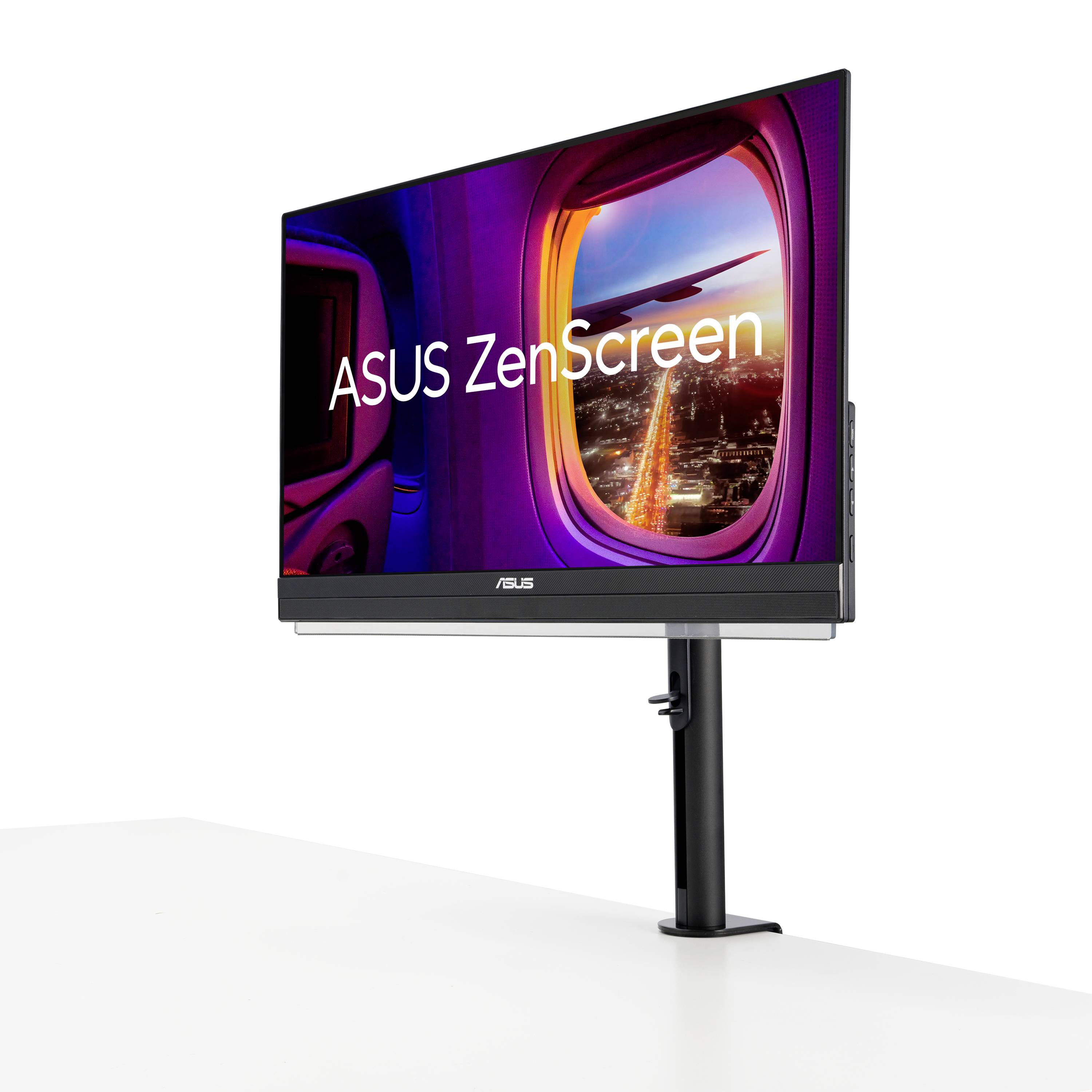 Monitor ASUS ZenScreen wyświetla obraz widoku samolotu podczas zachodu słońca. Ekran jest zamontowany na stole.