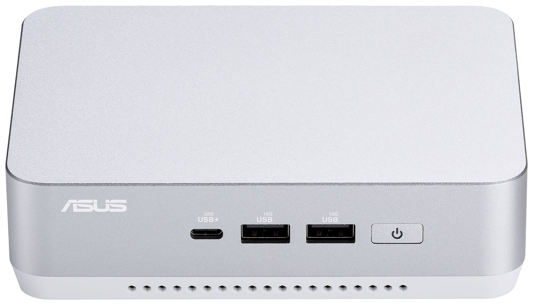 Srebrny minikomputerem Asus z dwoma złączami USB, jednym złączem USB-C oraz włącznikiem zasilania z przodu.