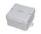 Szare, kwadratowe obudowa przyłączeniowa z zaokrąglonymi narożnikami, czterema otworami mocującymi i wyjmowanymi przepustami kablowymi.